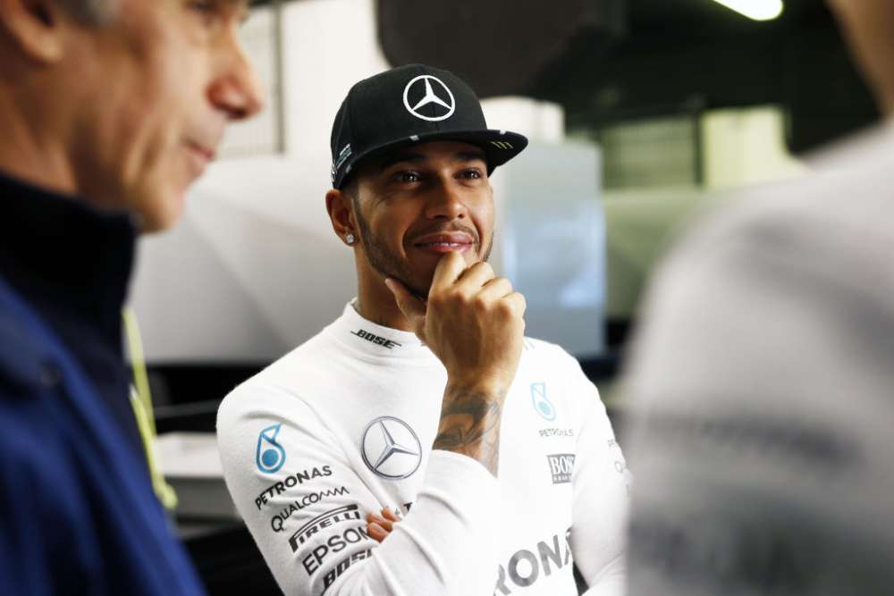 Lewis Hamilto looking happy in the garages